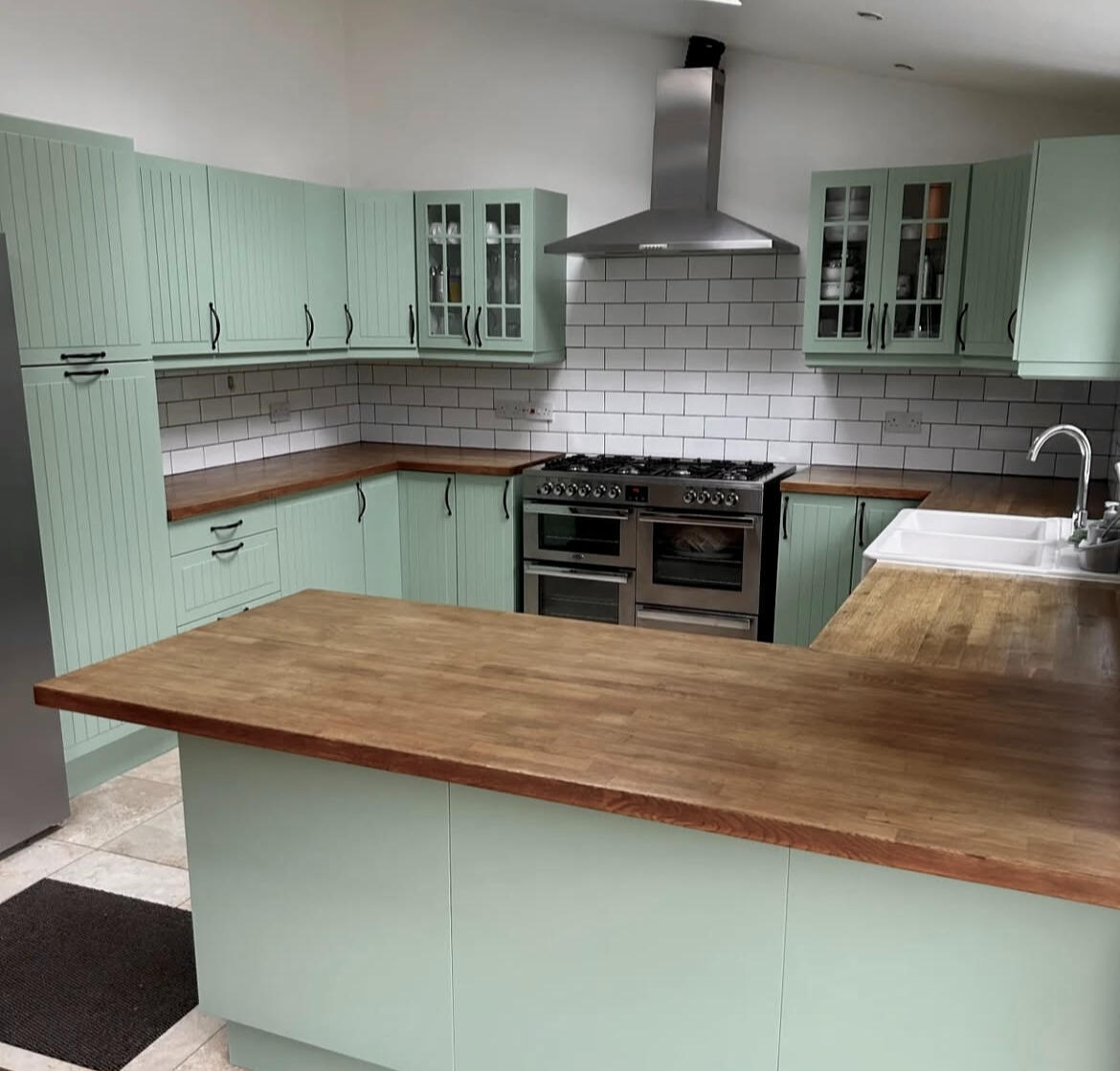 After After kitchen painting – professionally hand-painted sage green shaker kitchen by Wilkinson Specialist Sprays.