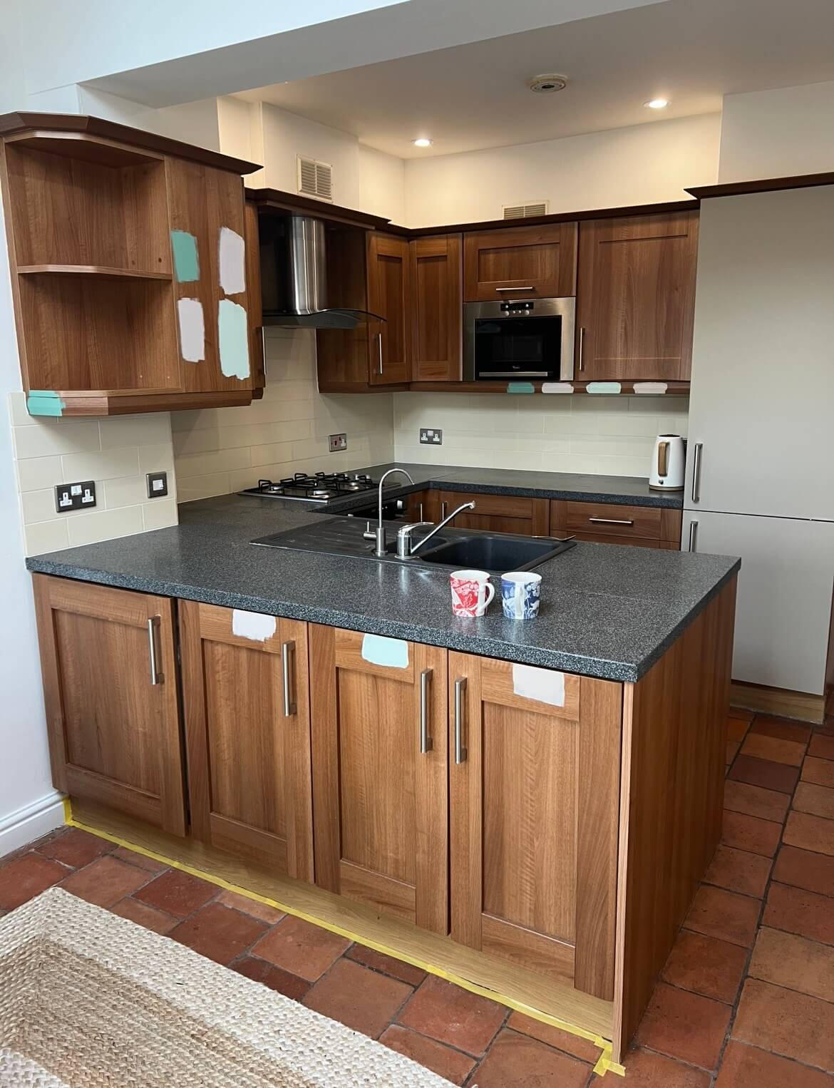 Traditional oak-effect kitchen before cabinet repainting by Wilkinson Specialist Sprays in Bridgnorth.